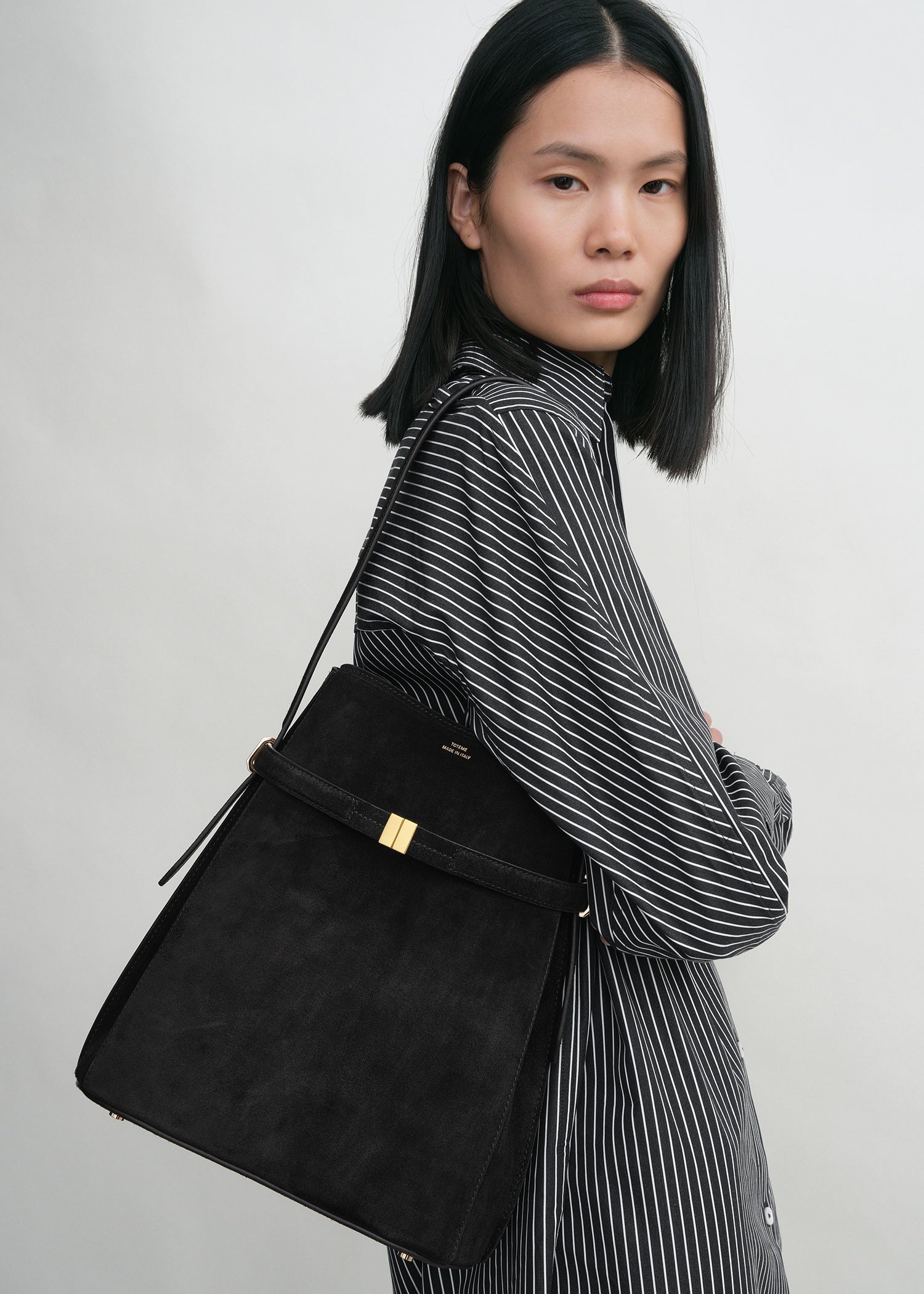 Belted suede bucket bag black